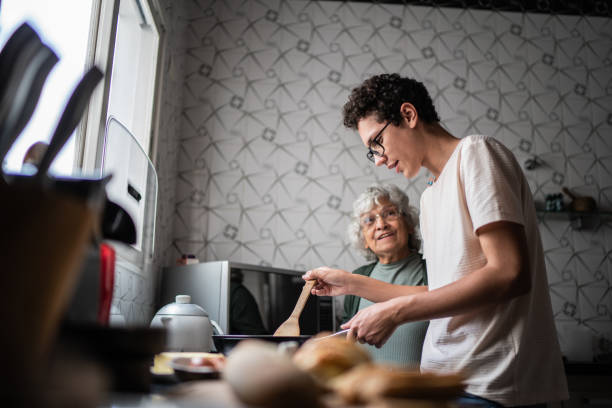 grandson and grandmother cooking at home - food stock pictures, royalty-free photos & images