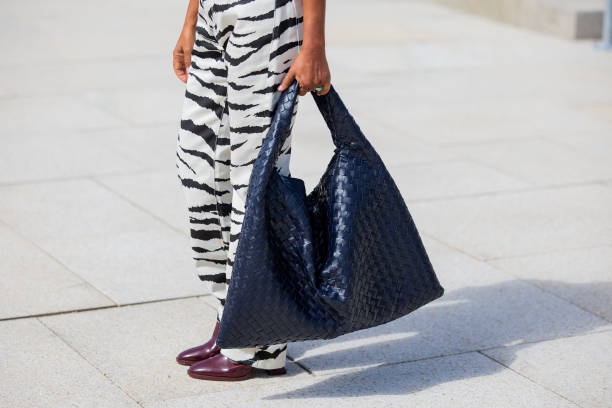 Grece Ghanem is seen wearing navy Bottega Veneta bag, zebra print pants outside OpéraSport during the Copenhagen Fashion Week SS25 on August 05, 2024...
