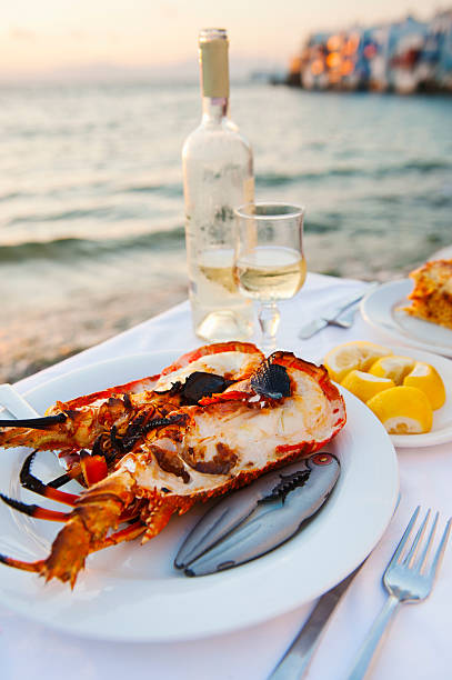 greece, cyclades islands, mykonos, lobser dinner at coast - food stock pictures, royalty-free photos & images