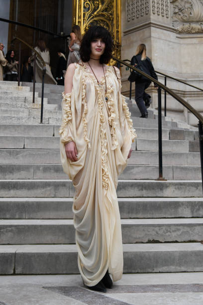 Greta Ferro wears cream ruffled long dress, black boots, outside Zimmermann during the Womenswear Fall/Winter 2025/2026 as part of Paris Fashion Week...