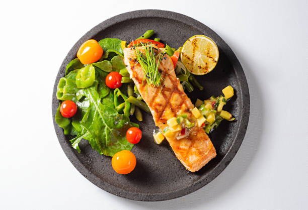 grilled salmon steak with green salad - food stock pictures, royalty-free photos & images