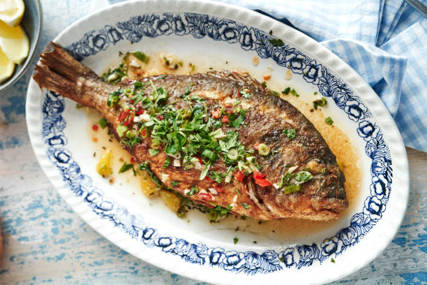 grilled sea beam with mojo isleno puerto rican sauce - food stock pictures, royalty-free photos & images