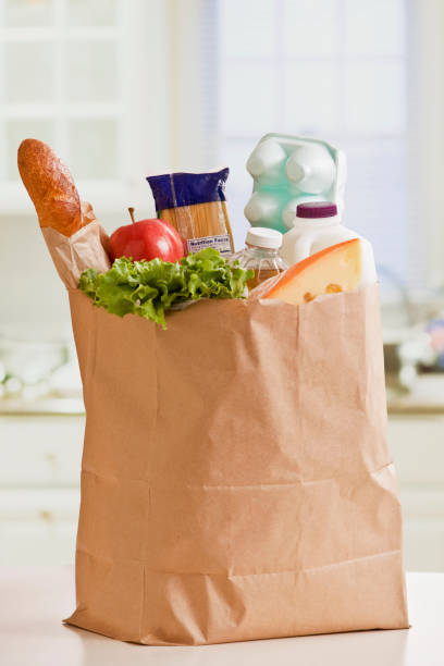 grocery bag full of groceries - food stock pictures, royalty-free photos & images