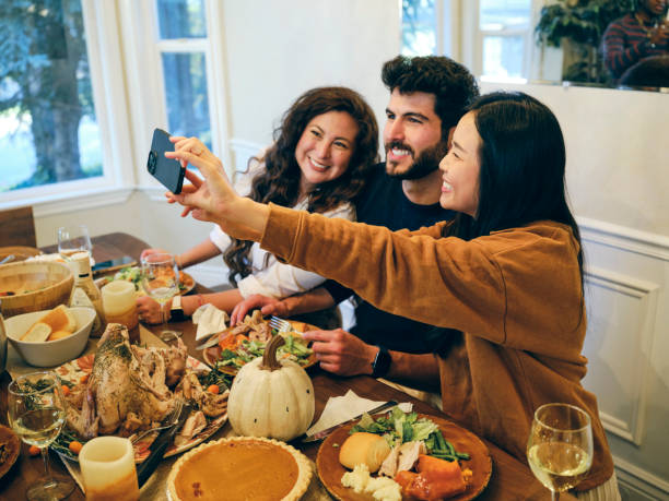 group of friends celebrating thanksgiving - home decoration stock pictures, royalty-free photos & images