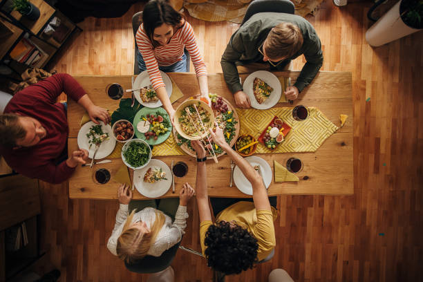 group of friends dining together - food stock pictures, royalty-free photos & images