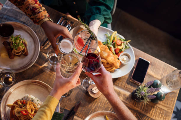 group of friends having a celebratory toast - food stock pictures, royalty-free photos & images