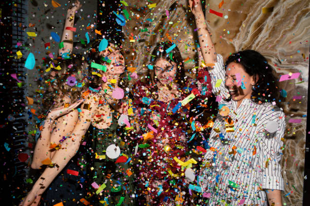 group of friends having fun with confetti at home. - fashion stock pictures, royalty-free photos & images
