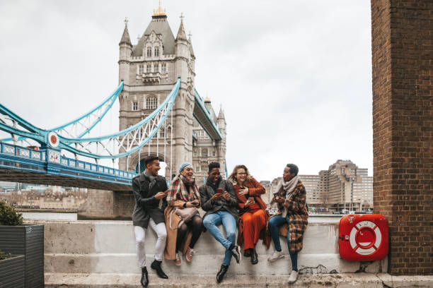 group of friends on vacation texting on mobile - travel stock pictures, royalty-free photos & images