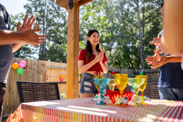 group of friends singing happy birthday at a party - garden decoration stock pictures, royalty-free photos & images