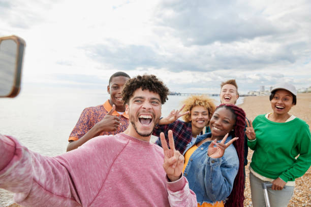 group of friends taking selfie on sunny beach - travel stock pictures, royalty-free photos & images