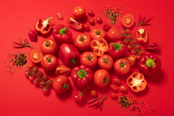 group of red vegetables isolated on red background - food stock pictures, royalty-free photos & images