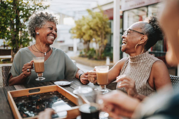 group of senior friends at coffee shop - coffee stock pictures, royalty-free photos & images