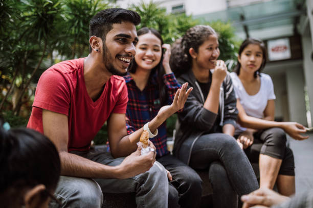 group of students joking and getting to know each other - junk food stock pictures, royalty-free photos & images