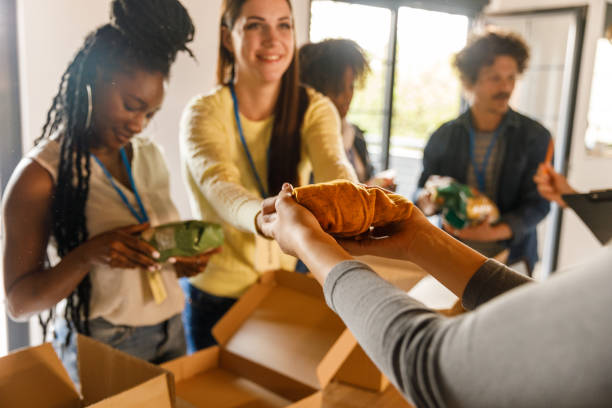 group of volunteers preparing donation boxes with clothes - food stock pictures, royalty-free photos & images