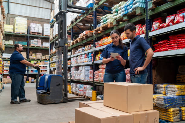 group of workers at a supermarket moving merchandise using a forklift - food stock pictures, royalty-free photos & images