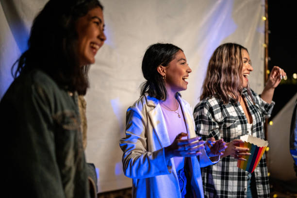 group of young friends dancing at a beach party - concert stock pictures, royalty-free photos & images
