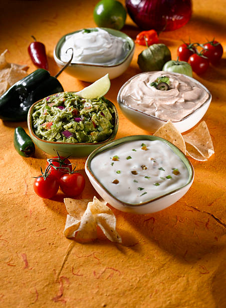 guacamole and mexican cheese dips - junk food stock pictures, royalty-free photos & images