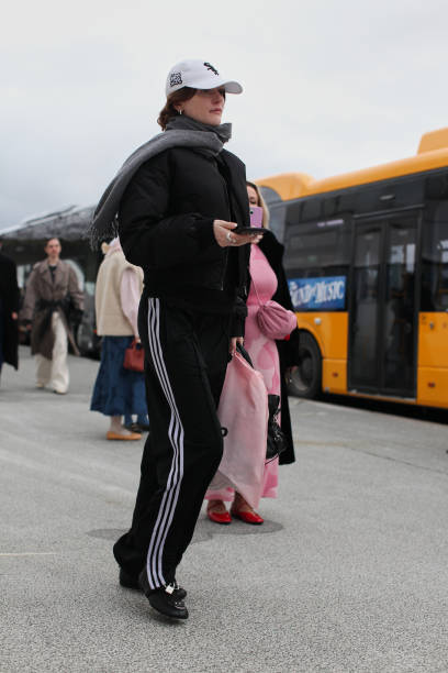 Guest is seen wearing a Black Blouson with a Pair of Adidas Track Pants outside Marimekko show during the Copenhagen Fashion Week Autumn/Winter 2025...