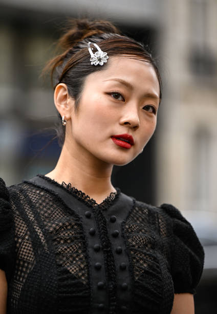 Guest is seen wearing a black ruffled sheer laced Rokh topand hair clip outside the Rokh show during the Womenswear Fall/Winter 2025/2026 as part of...