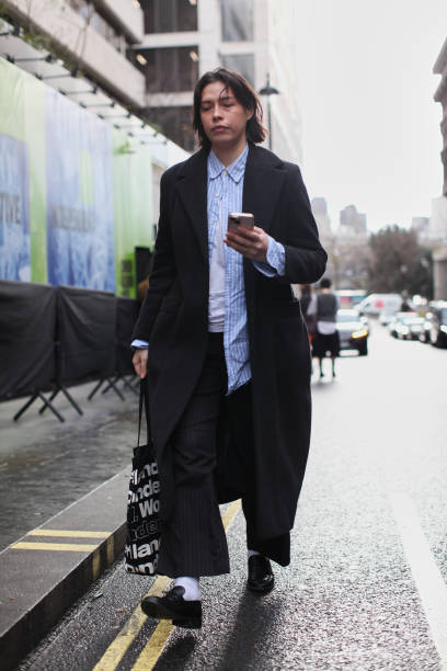 Guest is seen wearing a SB black wool coat with a pair black leather moccasins outside the S.S.Daley show during London Fashion Week February 2025 on...