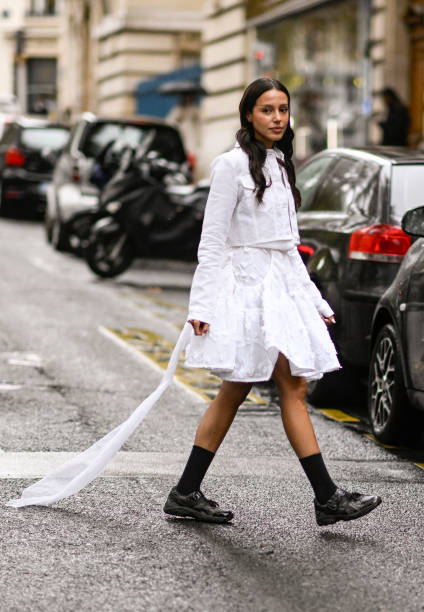 Guest is seen wearing a white Cecilie Bahnsen top and skirt with black shoes outside the Cecilie Bahnsen show during Womenswear Spring/Summer 2025 as...