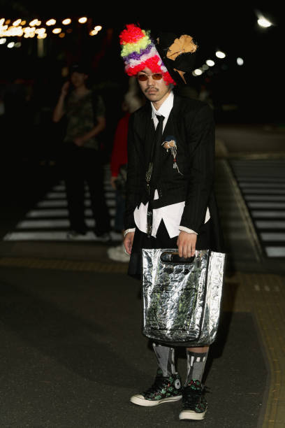 Guest is seen wearing white shirt, black jacket, shorts, Converse sneakers, silver bag during Rakuten Tokyo Fashion Week S/S 2025 on September 07,...