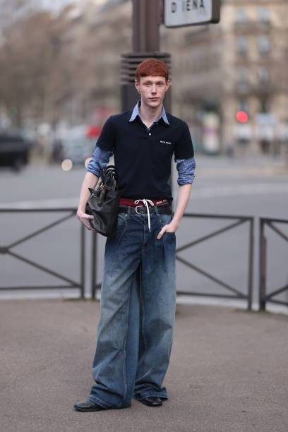 Guest seen wearing a Miu Miu navy blue Poloshirt over a blue shirt, Miu Miu large black leather bag, gold jewellery, Miu Miu red underwear with bow,...