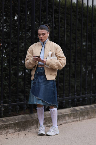 Guest seen wearing a yellow step jacket, white pullover, blue denim Lacoste jeans skirt, white high socks, white sneaker and a white leather bag...