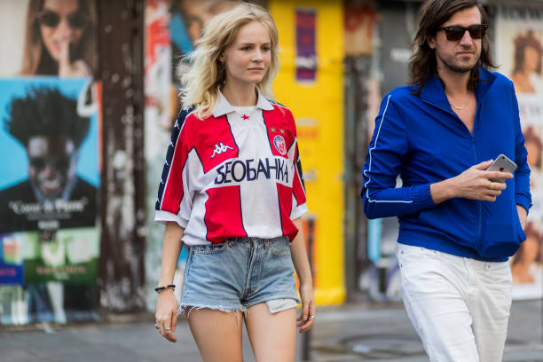 Guest wearing denim shorts and a football jersey outside Boris Bidjan Saberi during Paris Fashion Week - Menswear Spring/Summer 2018 on June 22, 2017...