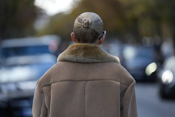 Guest wears a brown corduroy jacket, outside Miu Miu, during the Womenswear Spring/Summer 2024 as part of Paris Fashion Week on October 03, 2023 in...