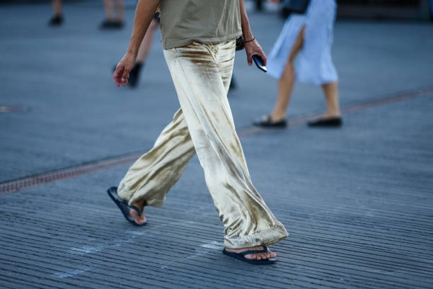 Guest wears a pale khaki tank-top, a pink and black leopard print pattern cotton shoulder bag, gold velvet large pants, black flip flop from...