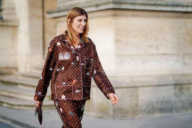Guest wears a Vuitton brown monogram pyjama outfit, outside Louis Vuitton, during Paris Fashion Week Womenswear Fall/Winter 2019/2020, on March 05,...