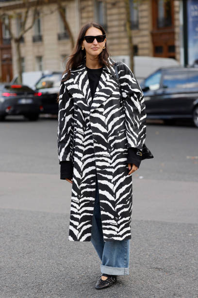 Guest wears black and white zebra print coat, outside Miu Miu, during Womenswear Spring/Summer 2025 as part of Paris Fashion Week on October 01, 2024...