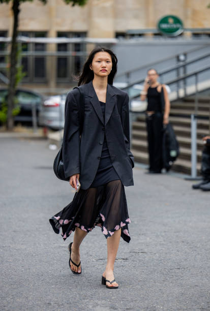 Guest wears black blazer, transparent skirt outside Lueder during the Berlin Fashion Week SS25 on July 01, 2024 in Berlin, Germany.