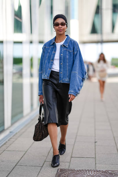 Guest wears black headband, black sunglasses, gold earrings, white t-shirt, navy blue denim jean oversized jacket, black capri pants, black leather...