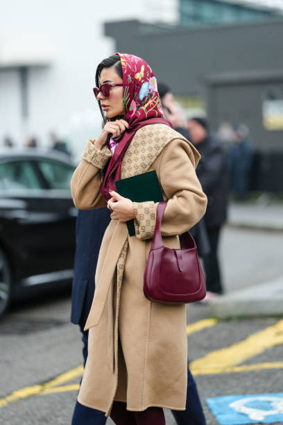 Guest wears burgundy bordeaux Gucci sunglasses, burgundy bordeaux floral pattern Gucci scarf, a gold ring, light brown Gucci monogram Gucci belted...