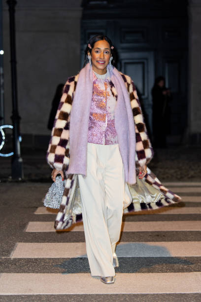 Guest wears checkered coat, lavender scarf, white pants outside Stine Goya during the Copenhagen Fashion Week AW24 on January 31, 2024 in Copenhagen,...