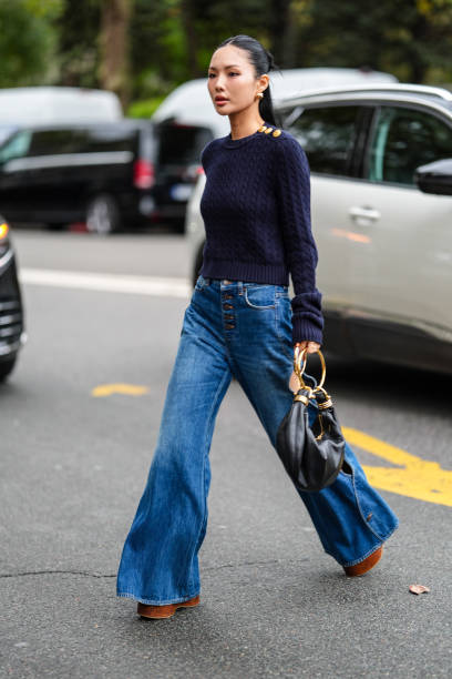 Guest wears gold earrings, navy blue knit sweater with gold detail, navy blue denim jean cutout pants, dark brown Chloe platform shoes, shiny black...