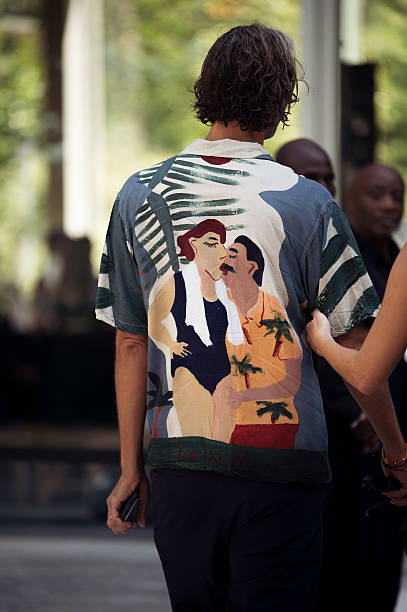 Guest wears graphic shirt and black pants outside Ardazaei show during the Haute Couture Fall/Winter 2025/2026 as part of Paris Fashion Week on July...