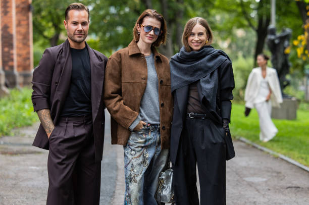 Guest wears suit & Marianne Theodorsen wears brown wild leather jacket, denim jeans with print, blue bag, grey shirt & Tine Andrea wears grey scarf,...