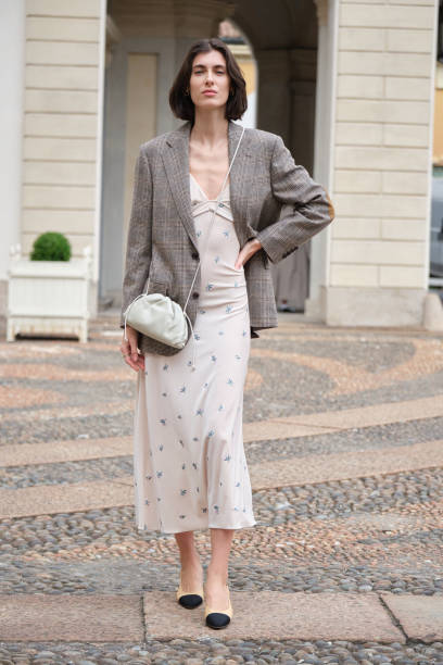 Guest wears twit gray jacket from Chanel and Luisa Beccaria floral dress during the Milan Fashion Week Menswear Spring/Summer 2025 on September 18,...
