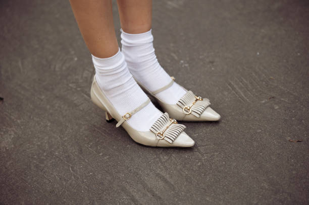 Guest wears white socks and grey or silver pointy shoes outside the Vivetta fashion show during the Milan Fashion Week Womenswear Fall/Winter...