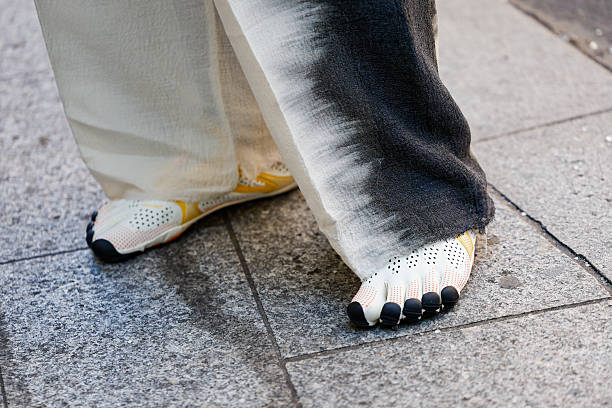 Guest wears white tabi sneakers, outside Kartik Research, during the Menswear Spring/Summer 2026 show as part of Paris Fashion Week on June 29, 2025...