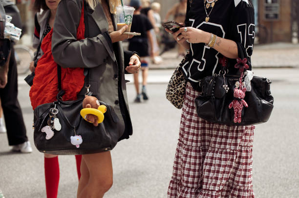 Guests holds black leather bags with accessories outside the Gestuz show during day four of the Copenhagen Fashion Week SS25 on August 08, 2024 in...