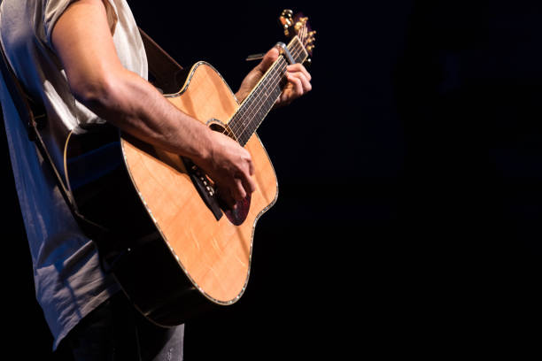 guitarist - singer playing the guitar during his concert - concert stock pictures, royalty-free photos & images