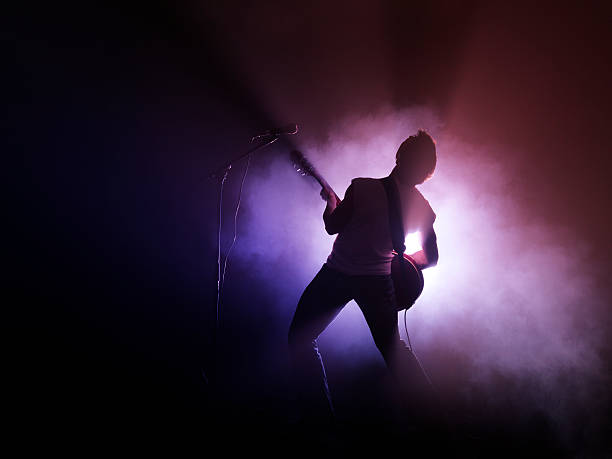 guitarist performing on stage - concert stock pictures, royalty-free photos & images