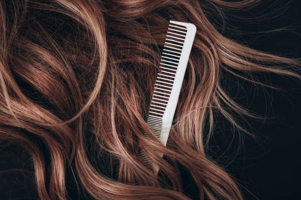haircomb hairbrushing brown hair. - hairstyle stock pictures, royalty-free photos & images