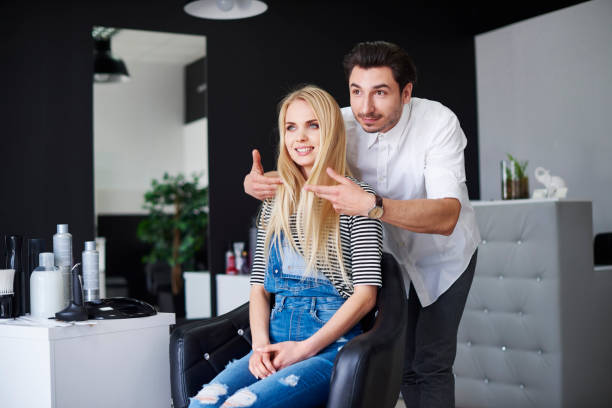 hairdresser advising his customer - hairstyle stock pictures, royalty-free photos & images