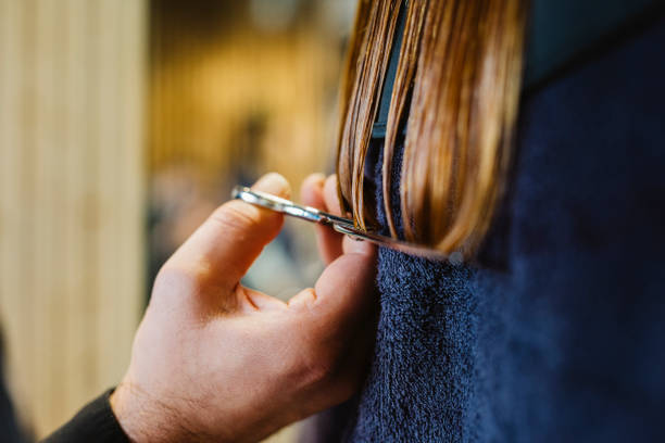 hairdresser cutting a woman's hair - hairstyle stock pictures, royalty-free photos & images