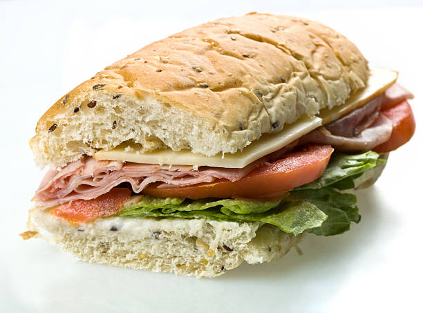 half ham and cheese submarine sandwich - junk food stock pictures, royalty-free photos & images